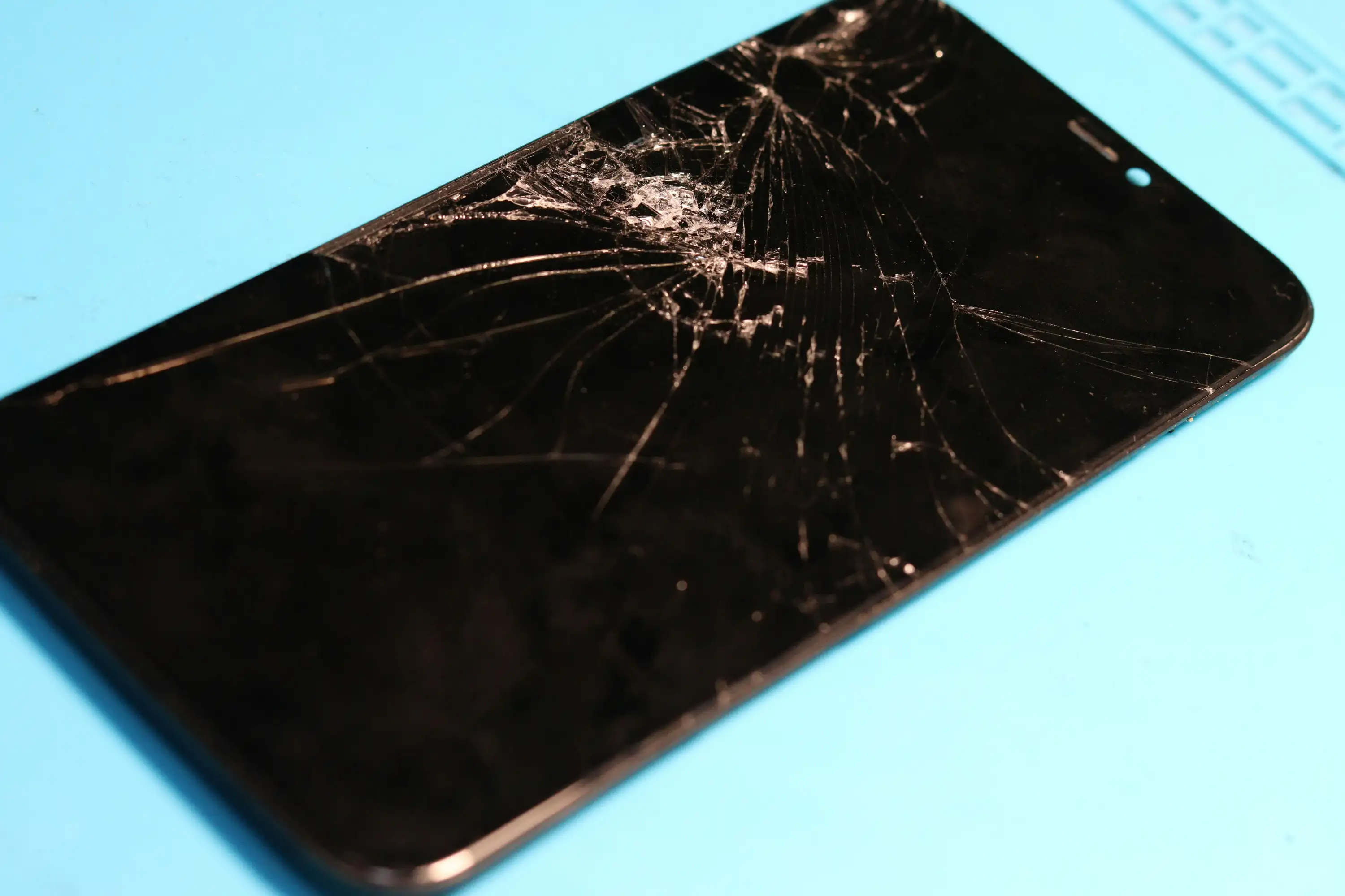 Customer selling a cracked smartphone at Phone Fix Pro in Nairobi for instant cash offer.